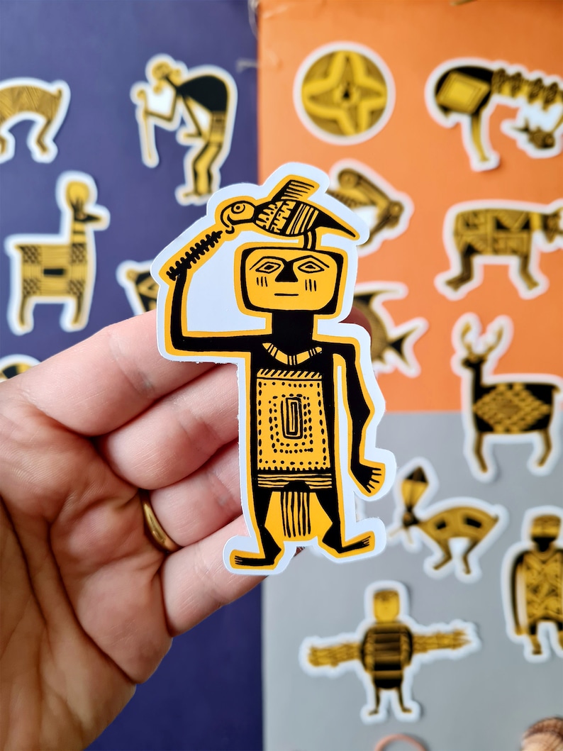 May include: A yellow and black sticker of a stylized human figure holding a bird above its head. The figure is wearing a patterned headdress and a patterned skirt. The sticker is on a white background.