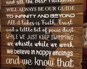 May include: A wooden sign with a black silhouette of Mickey Mouse's head. The sign has white text that reads "In This House we let it go Because Hakuna Matata and all the Bear Necessities will always be our guide to infinity and beyond All it takes is Faith. Trust and a little bit of pixie dust while we just keep swimming we whistle while we work we believe in happy endings and we know that life is always better under the sea BECAUSE IN THIS HOUSE We Do Disney."