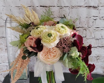 Wine Brides bouquet with Real touch orchids, ferns and eucalyptus. White roses, light blush Ranunculus and cabbage roses with pampas grass.