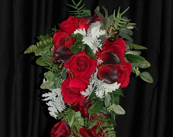 Cascading burgundy red rose, calla lily and gladiolus. Seeded eucalyptus, grey dusty miller, olive branches and various ferns.