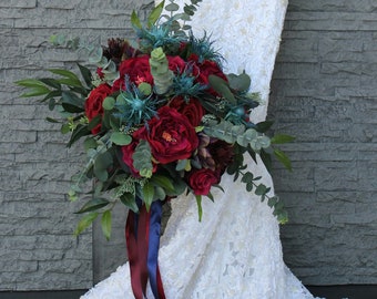 Jewel toned wedding bouquets burgundy, wine and red with blue thistles real touch eucalyptus and smilax.