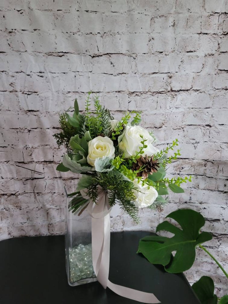 Winter Boho bouquet with White roses, and pine cones, evergreen and eucalyptus and dusty miller. image 1