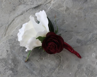 Garden Boho Rose boutonniere, with white rose, burgundy ranunculus and seeded eucalyptus. Wrapped in burgundy satin ribbon.