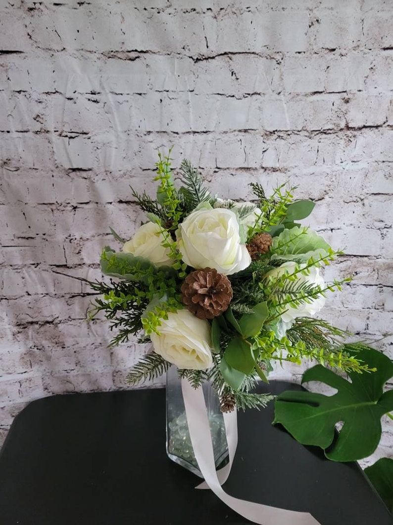 Winter Boho bouquet with White roses, and pine cones, evergreen and eucalyptus and dusty miller. image 3