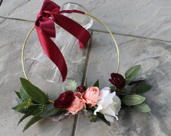 Garden Boho Floral hoop in burgundy ranunculus and dusty peach cupped roses, white rose, seeded eucalyptus on a gold hoop, burgundy ribbon