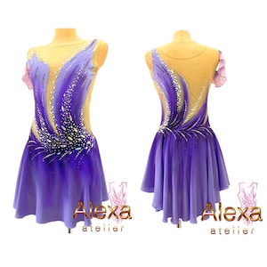 May include: Purple and light purple figure skating dress with a sheer bodice and a design of swirling lines and rhinestones. The dress has a short skirt with a scalloped hem. The dress is on a mannequin. The text "Alexa atelier" is on the bottom of the image.