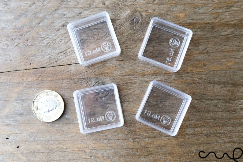 May include: Four clear plastic square containers with the text "No. 1" printed on each container.