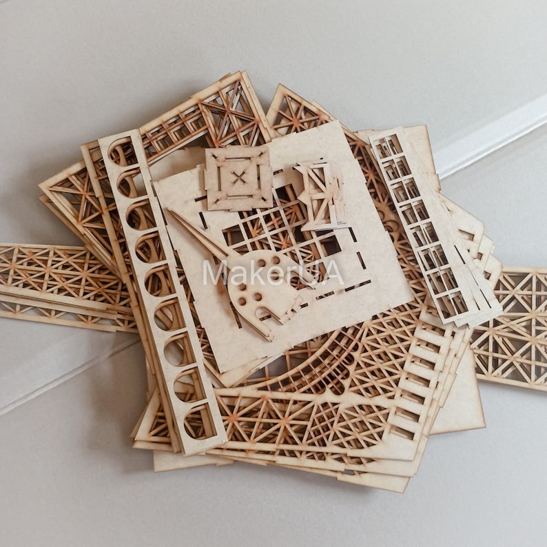 May include: A set of laser cut wooden pieces for a model building project. The pieces are intricate and detailed, with a variety of shapes and sizes. The pieces are made of light brown wood and are ready to be assembled.