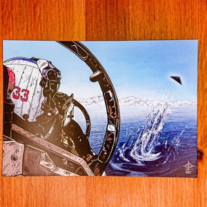 May include: A close-up view from inside a fighter jet cockpit. The pilot is wearing a helmet with the number 33 on it. The view outside the cockpit shows a blue sky, white clouds, and a dark triangular object flying in the distance. The object is leaving a trail of white smoke behind it.