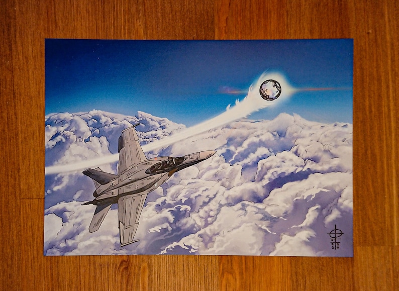 May include: A grey fighter jet flies through a cloudy sky with a bright white contrail behind it. A large, round, white object with a dark centre is visible in the upper right corner of the image.