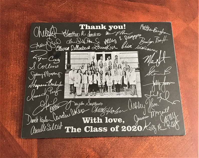 May include: Black and white photo of a group of people in white coats standing on a set of stairs. The photo is surrounded by handwritten signatures and the text "Thank you!" and "With love, The Class of 2020".