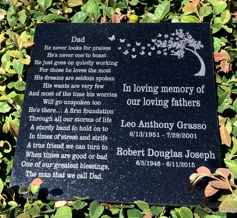 May include: Black granite memorial plaque with a poem about a father and a tree with butterflies in the background. The plaque reads "In loving memory of our loving fathers" and includes the names and dates of birth and death of Leo Anthony Grasso and Robert Douglas Joseph.