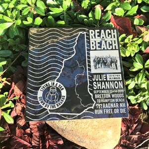 May include: Black and white image of a map of New Hampshire with the text "Reach the Beach" and "Julie Shannon" on it. The image also includes the text "Living in a Van Down by the Ragnar" and "Ragnar NH Run Free or Die".