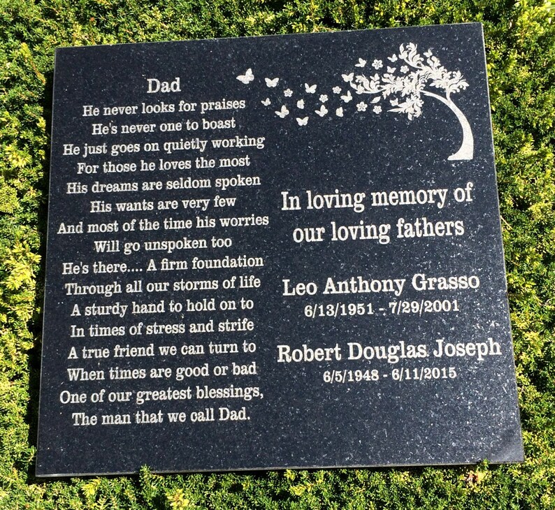 May include: Black granite memorial plaque with a silver inscription honoring two fathers. The inscription includes a poem about a father's love and support, followed by the names and dates of birth and death of Leo Anthony Grasso and Robert Douglas Joseph.