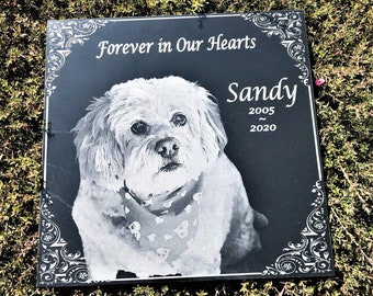 May include: Black granite pet memorial with a white dog portrait, the text "Forever in Our Hearts" and the name "Sandy" with the years 2005 and 2020.