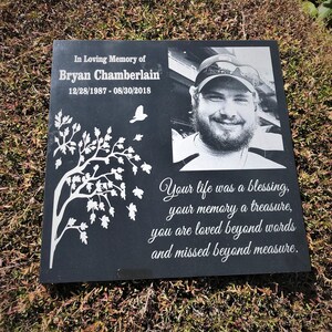 May include: Black granite memorial stone with a white etched tree, a photo of a man, and the text "In Loving Memory of Bryan Chamberlain 12/28/1987 - 08/30/2018 Your life was a blessing, your memory a treasure, you are loved beyond words and missed beyond measure."
