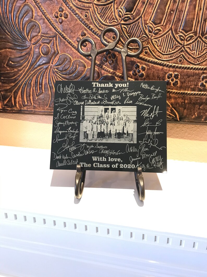 May include: A black and white photo of a graduating class with signatures and the text "Thank you!" and "The Class of 2020" on a black background.