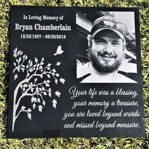 May include: Black granite memorial stone with a photo of a man, a tree with leaves, and the text "In Loving Memory of Bryan Chamberlain 12/28/1987 - 08/30/2018 Your life was a blessing, your memory a treasure, you are loved beyond words and missed beyond measure."