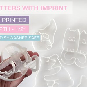 May include: Clear 3D-printed cookie cutters with imprint. The image shows a variety of shapes, including a gnome, two cats, a bear, and a rocking horse. The depth of the cutters is 1/2 inch. The text on the image says "CUTTERS WITH IMPRINT", "3D PRINTED", "DEPTH - 1/2", and "NOT DISHWASHER SAFE".