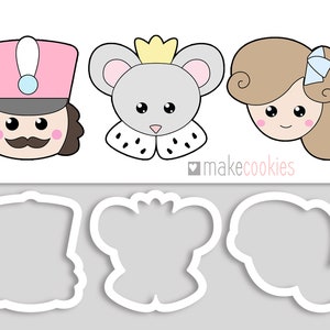 May include: Three cookie cutters, one shaped like a nutcracker, one shaped like a mouse wearing a crown, and one shaped like a girl with a bow in her hair. The cutters are white and are on a gray background.