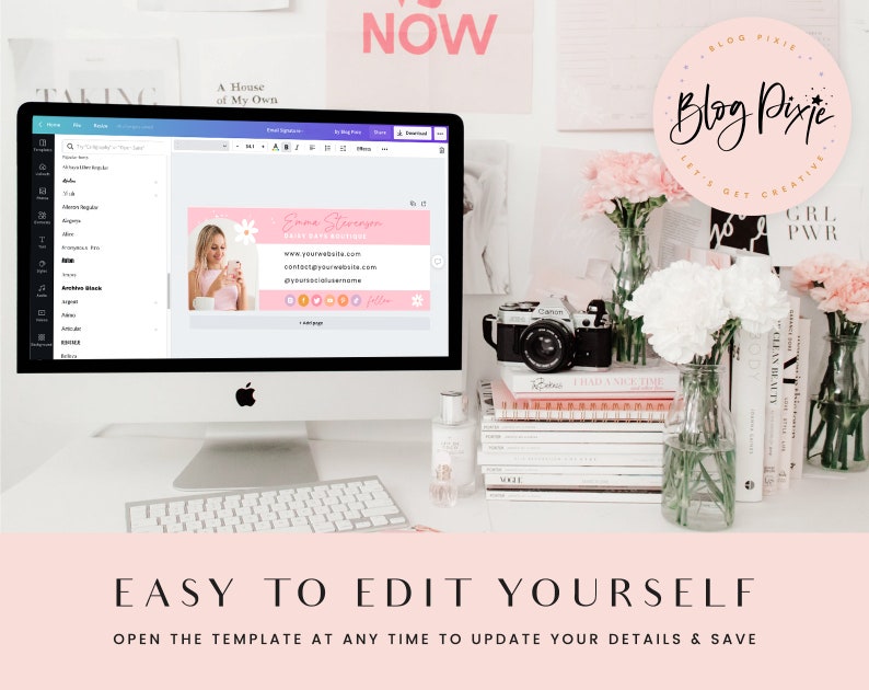 May include: A pink and white digital business card template with the text "Emma Stereagen" and "Blog Pixie" on a computer screen. The screen is on a white desk with a camera, flowers, and books.