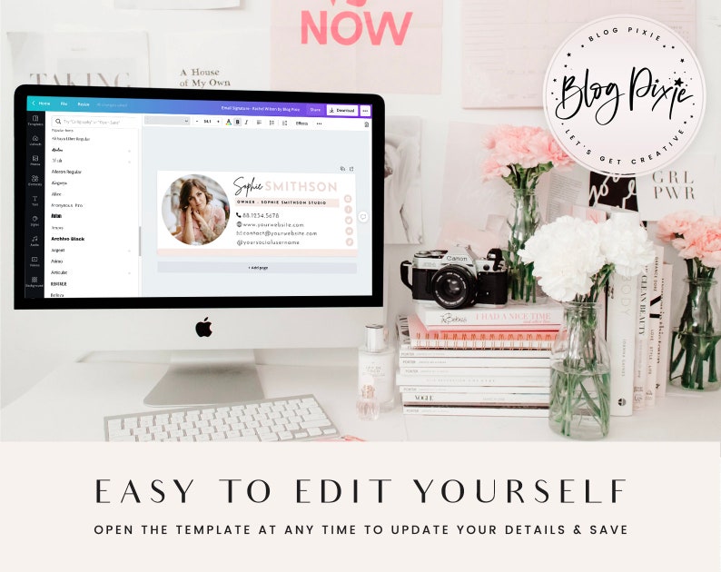 May include: A computer screen showing a pink and white business card template with a woman's photo and the text "Sophie SMITHSON" and "OWNER, Sophie Smithson Studio". The screen is on a white desk with a camera, flowers, and books.