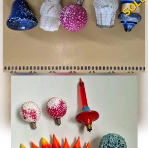 May include: Vintage Christmas light bulbs in various shapes and colors. Includes a blue bell, snowman, pink ball, white cupcake, and blue and gold bulb. The bottom row features red and orange flame-shaped bulbs and a blue glitter ball. Text reads "Sold Separately" and "Choice".