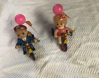 Vintage Tin Wind Up Made in Korea Boy and Girl Riding Tricycles with Balloons