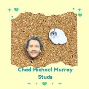 May include: A pair of stud earrings featuring a printed image of Chad Michael Murray's face. The earrings are on a corkboard background with the text "Chad Michael Murray Studs" in teal.