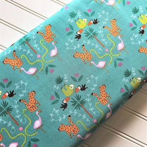 May include: Teal fabric with a repeating pattern of orange and black leopards, green sloths, pink flamingos, green snakes, and toucans. The pattern is set against a background of green palm trees and vines.