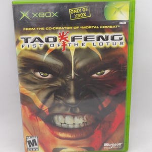 May include: Xbox game case for "Tao Feng: Fist of the Lotus." The cover features a close-up of a fierce face with red and orange tones. The game is rated M for Mature and is from Microsoft Game Studios.