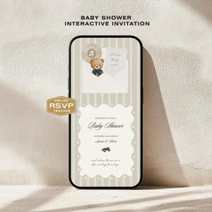 May include: A smartphone screen displaying a digital baby shower invitation with a beige striped background. The design features a teddy bear in an envelope, a music icon, and a scalloped white frame with text including Baby Shower, Lauren & Steven.