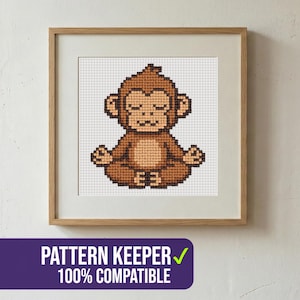May include: A framed cross-stitch pattern of a meditating monkey in shades of brown. The monkey is in a lotus position with its eyes closed. The frame is light brown. Text at the bottom reads "PATTERN KEEPER 100% COMPATIBLE".