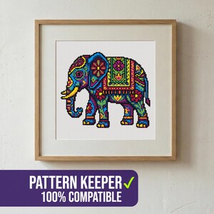 May include: A framed cross-stitch pattern of a colorful elephant with intricate floral and geometric designs. The elephant is primarily blue, green, yellow, and red. The frame is a light brown wood. The text "PATTERN KEEPER 100% COMPATIBLE" is at the bottom.