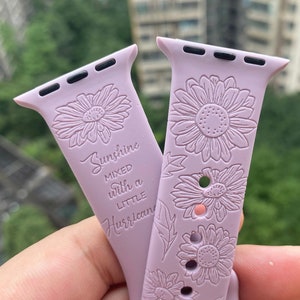 May include: A light purple Apple Watch band with a floral design and the text "Sunshine mixed with a little hurricane".