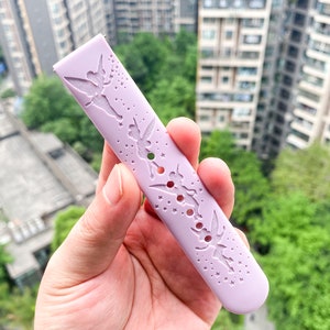 May include: A lavender silicone watch band with a cut-out design of Tinkerbell and stars.