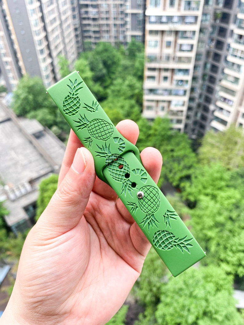 May include: Green silicone watch strap with a pineapple design.