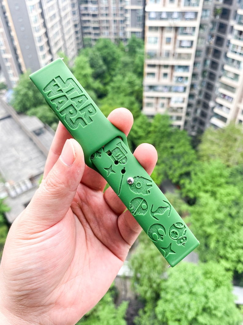 May include: Green silicone watch strap with the words "STAR WARS" embossed on the top and various Star Wars characters embossed on the bottom.