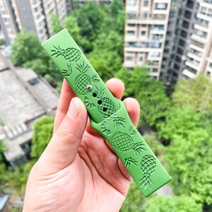 May include: Green silicone watch strap with a pineapple design.