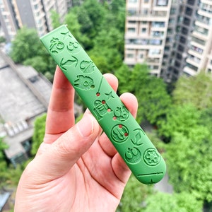 May include: Green watch strap featuring a Star Wars theme. The strap is embossed with various Star Wars characters and symbols, including the Death Star, R2-D2, and the Millennium Falcon.