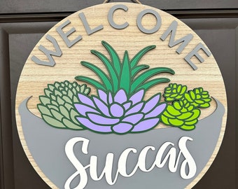 A "Welcome Succas" Succulent-Themed Round Sign/Door Hanger, Perfect for Displaying on Front Door, Customize Colors and Comes in 2 Sizes