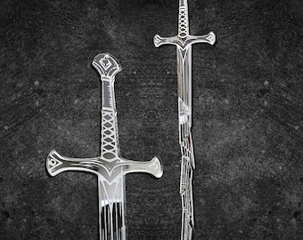 May include: Two silver swords with intricate designs. The swords have cross-shaped hilts and detailed patterns on the handles and blades. The blades have a reflective surface, and the background is a dark, textured gray.