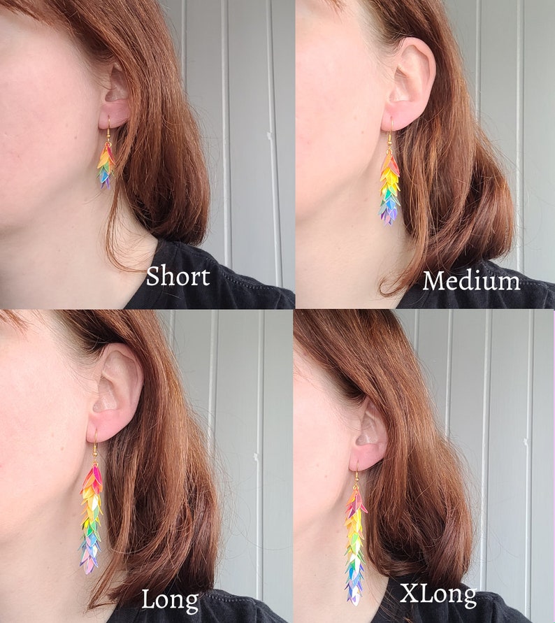 May include: Four pairs of rainbow-colored dangle earrings in different lengths: short, medium, long, and extra long. The earrings are made of iridescent plastic and have a gold hook.
