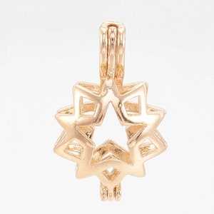 May include: Gold-toned metal star-shaped locket pendant with a hinged opening. The locket is designed to hold a small charm or pearl.