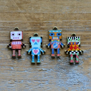 May include: Four colorful robot charms with different designs. The robots are made of metal and have a shiny finish. They are all about 1 inch tall.