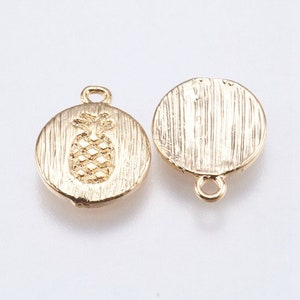 May include: Two gold-toned metal charms, one with a pineapple design and the other plain, both with a loop for attaching to jewelry or other crafts.