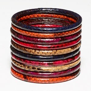 May include: A stack of 12 colorful bangles made of wood and painted with a snakeskin pattern. The bangles are in shades of red, orange, brown, and blue.