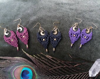 May include: Three pairs of handmade macrame earrings with gold crescent moon charms. The earrings are in shades of purple, black, and dark purple.