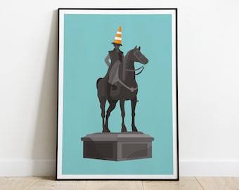 May include: A black and gray statue of a person on horseback wearing an orange traffic cone hat. The statue is on a gray base and is set against a light blue background.
