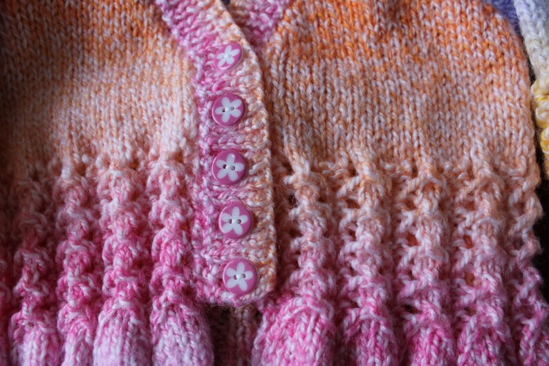 Baby girl/'s knitted multi coloured cardigan new born size.